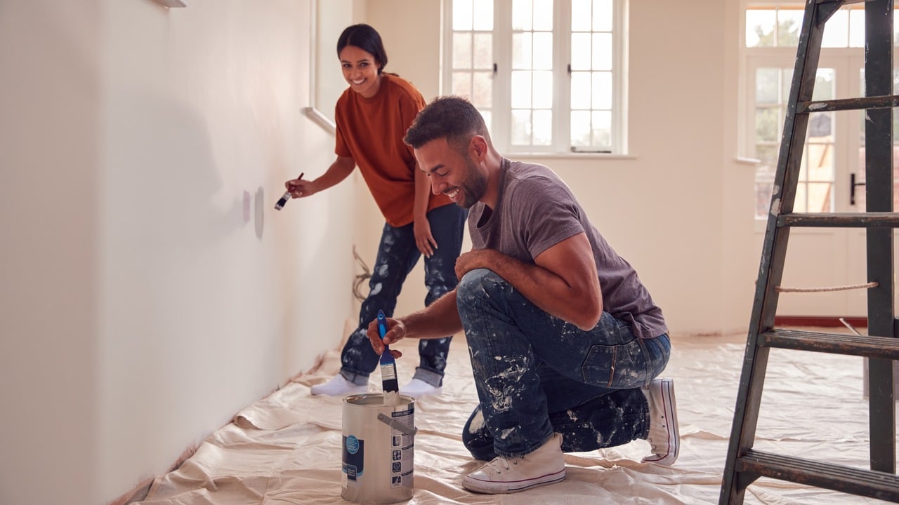 Painter working carefully in a bright finished room